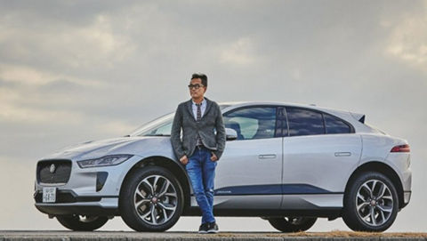 Blue jeans man standing in-front of JAGUAR