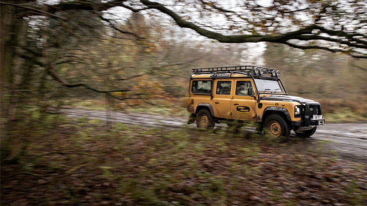 Land Rover Defender Works V8 Trophy driving on forest road