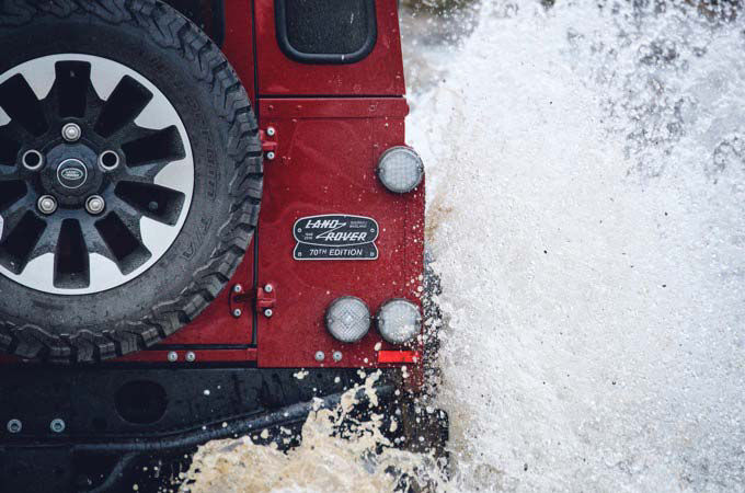 Close up of Land Rover Defender Works V8 70th edition badge and spare wheel