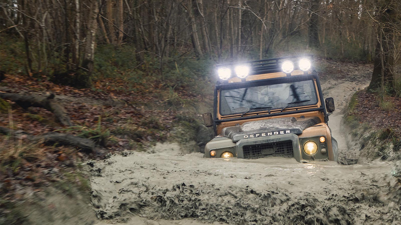 Land Rover Defender Works V8 Trophy driving through water 