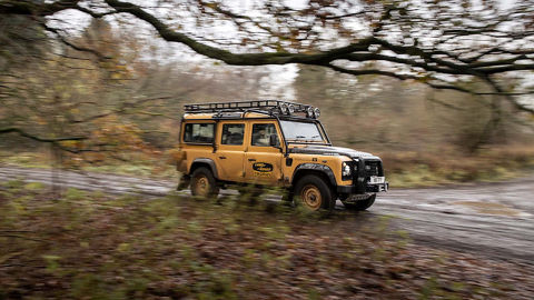 Land Rover Defender Works V8 Trophy driving on forest road