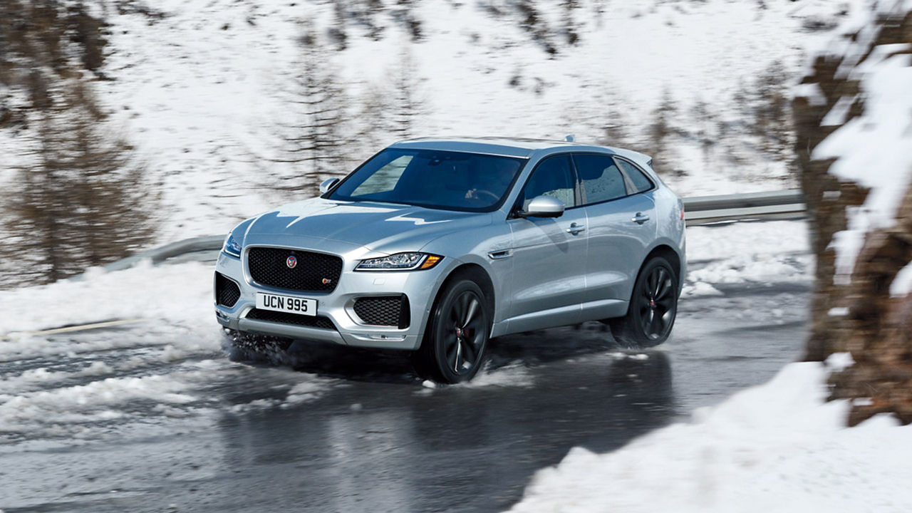 Jaguar F-Pace running on the snowy road