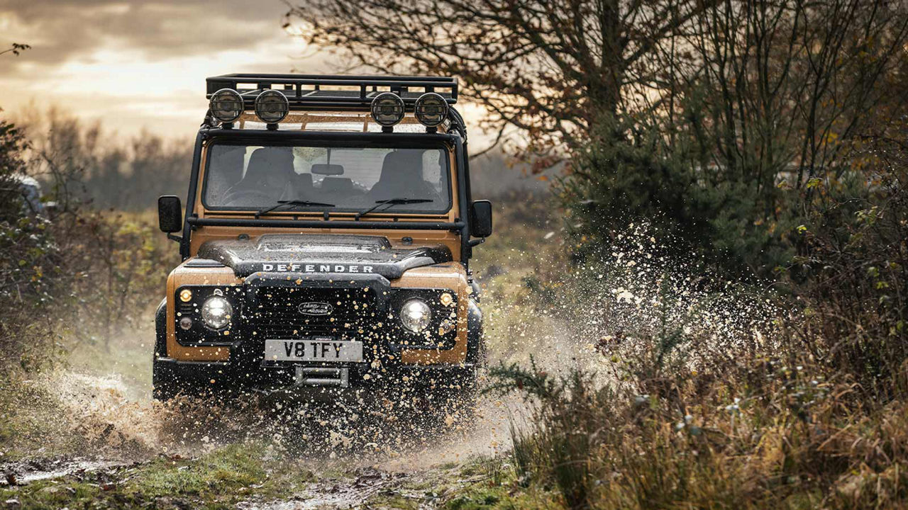 Land Rover Defender Works V8 Trophy driving through water 