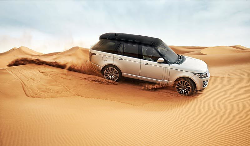 Range Rover driving on sand