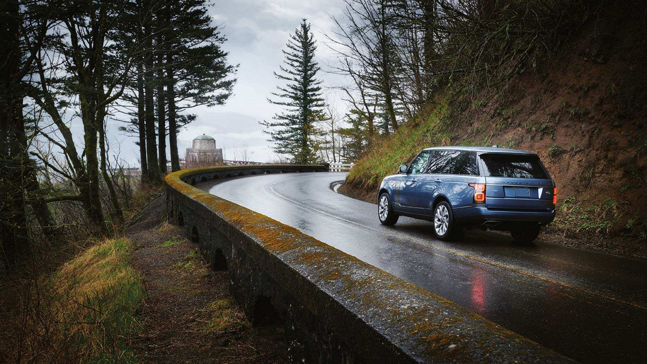 Land Rover vehicle driving in a rainy day