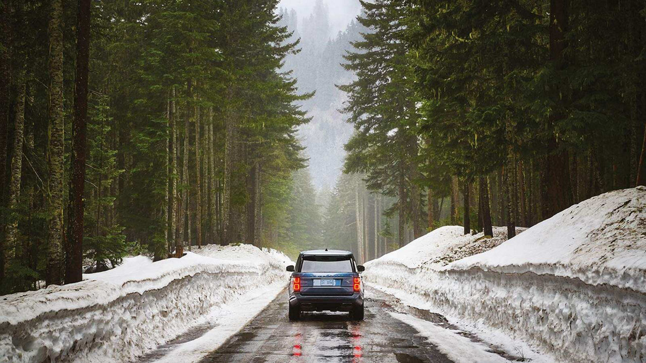 Range Rover HSE is driving in snowy road