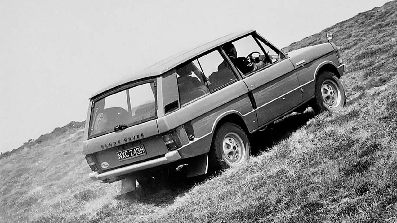 Black and white photo of Classic Range Rover driving up steep hill