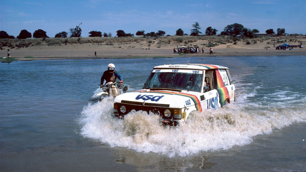 Classic Range Rover driving through water 