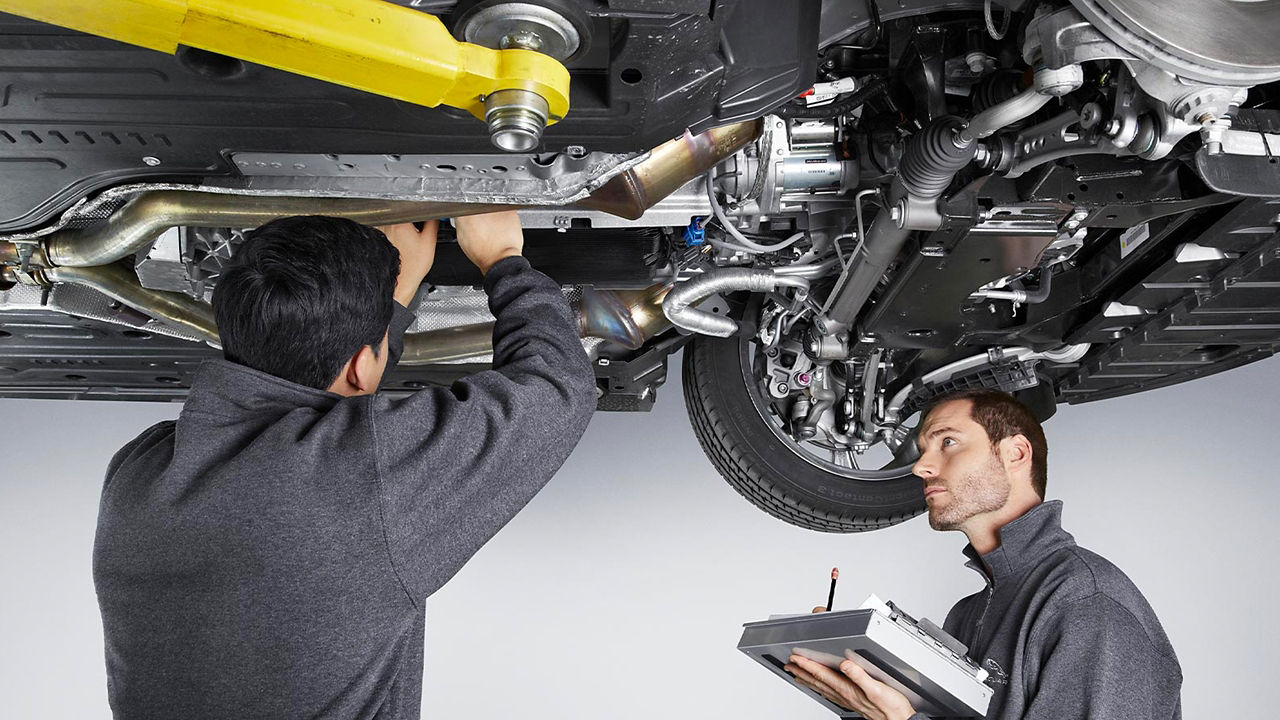 Jaguar service center mechanic checking vehicle