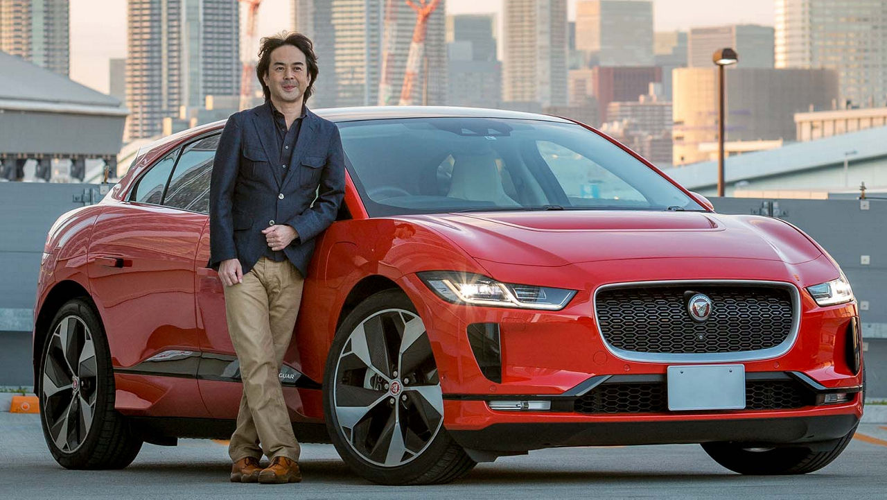 Hiroaki Tanaka in front of a red I-Pace