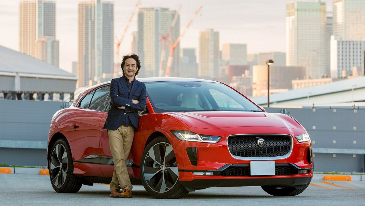 Hiroaki Tanaka in front of a red Jaguar I-Pace