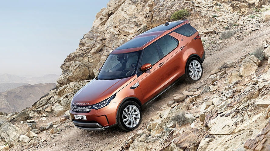 Land Rover Discovery driving down rocky mountain road