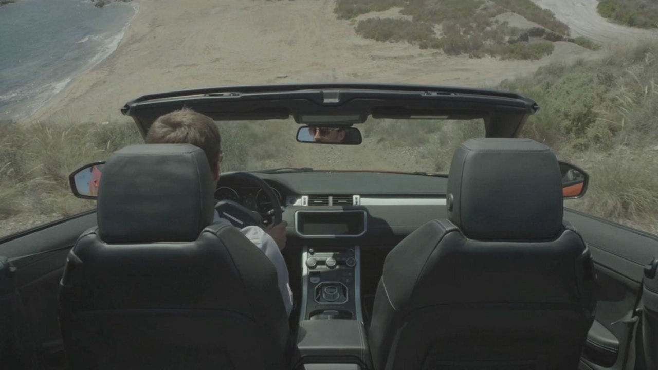 View of Convertible Range Rover cockpit while driving down hill