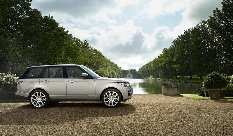 Range Rover parked next to water 