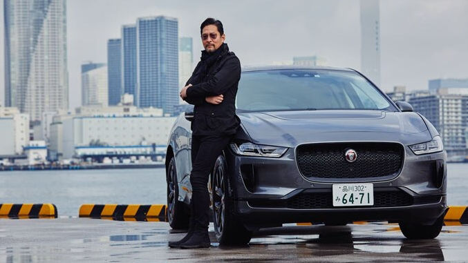 Man standing near river with JAGUAR