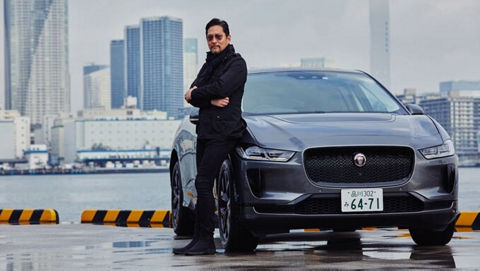 Man standing near river with JAGUAR