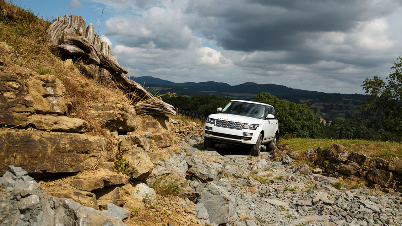 Range Rover driving on rocks