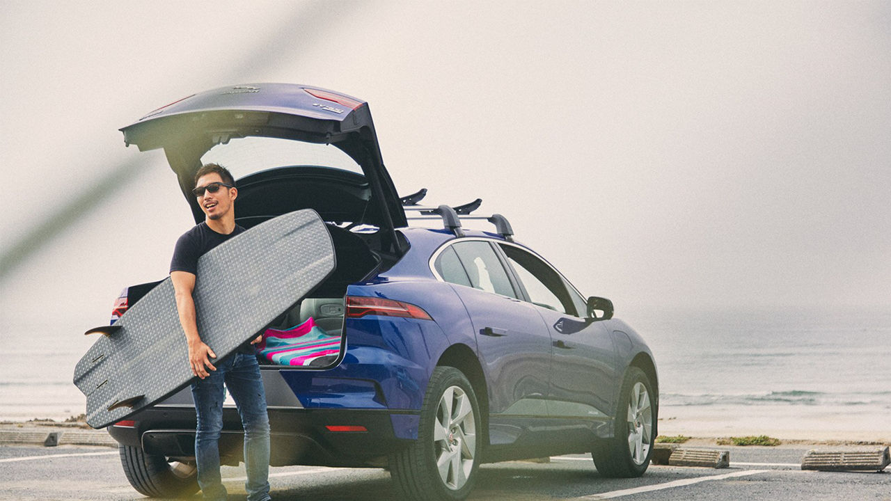 Ryosuke Nishida packs his surfing equipment in a Jaguar I-Pace