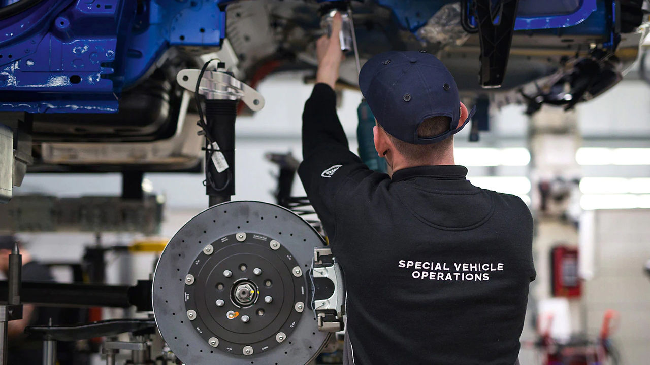 Jaguar service center mechanic checking vehicle