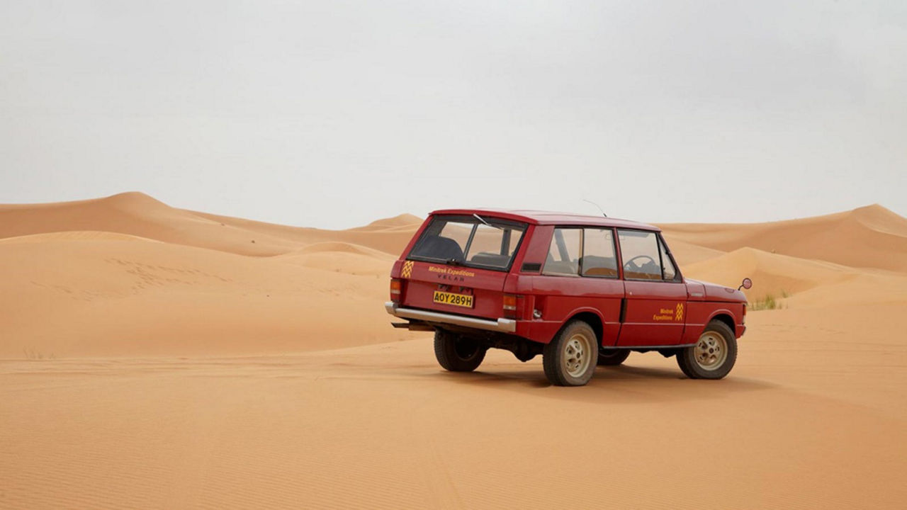 Classic Range Rover driving in desert 