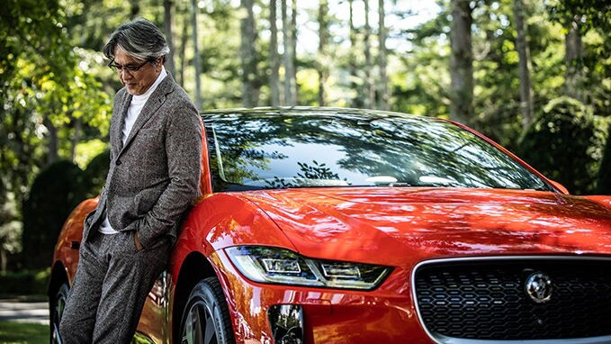 man in-front of orange JAGUAR