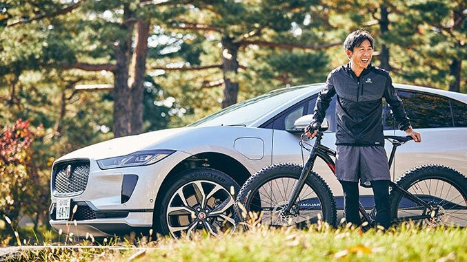 man laughing with bike and White JAGUAR