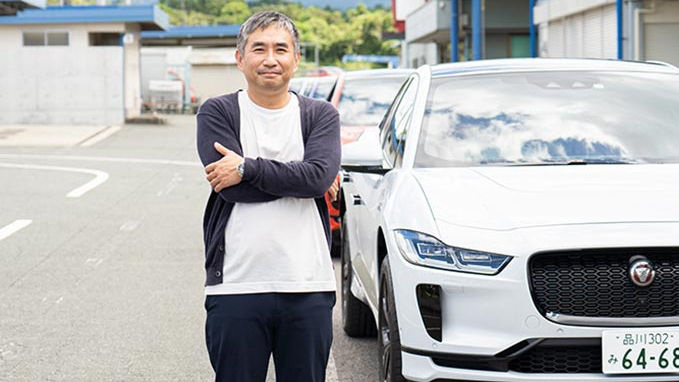 man posing in-front of White JAGAUAR