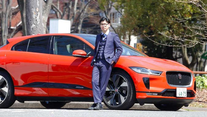 man posing with orange JAGUAR