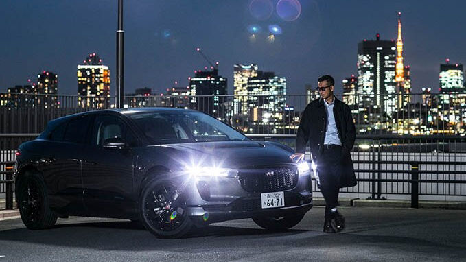 man walking at night in-front JAGUAR