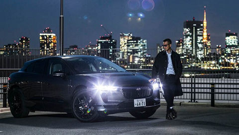 man walking at night in-front JAGUAR