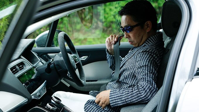 Masamichi Ishii sitting in his I-Pace