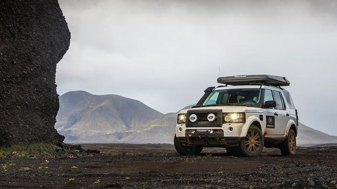 Land Rover parked on gravel in Iceland landscape