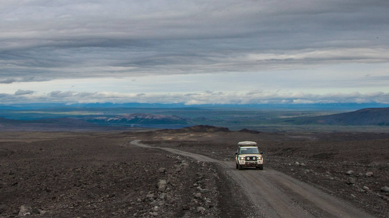 Land Rover driving on gravel road