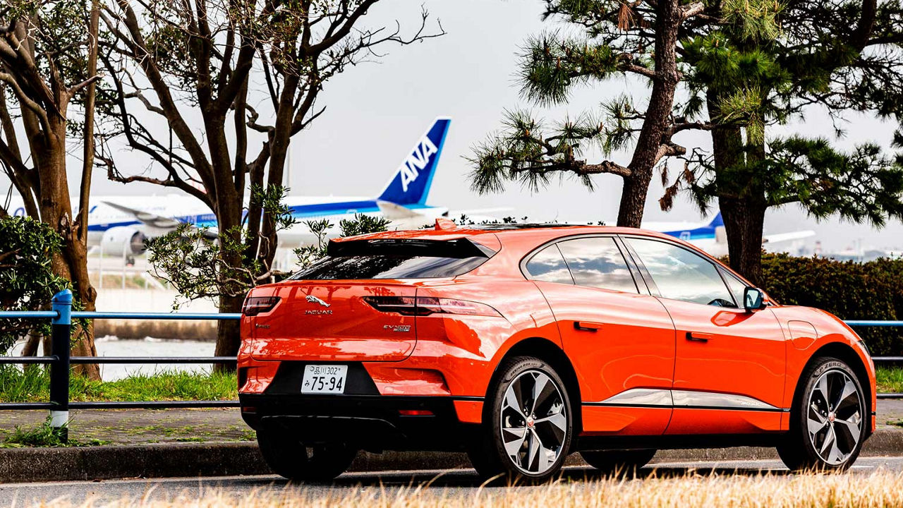 orange JAGUAR parked near airport