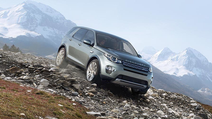 Range Rover discovery driving down rocky mountain path 