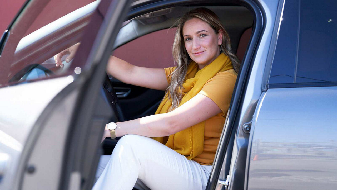 Ashley sitting inside her spacious F-Pace