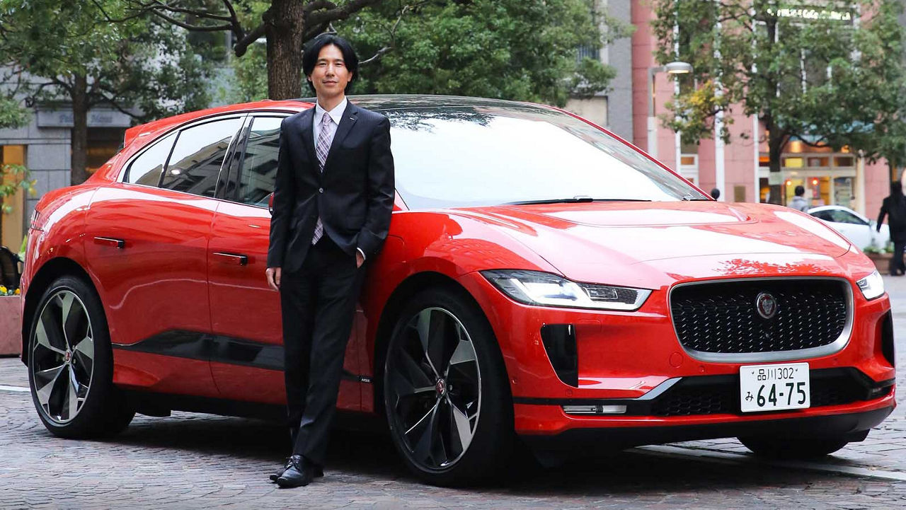 Tatsuya Shiozaki in front of a Jaguar I-Pace