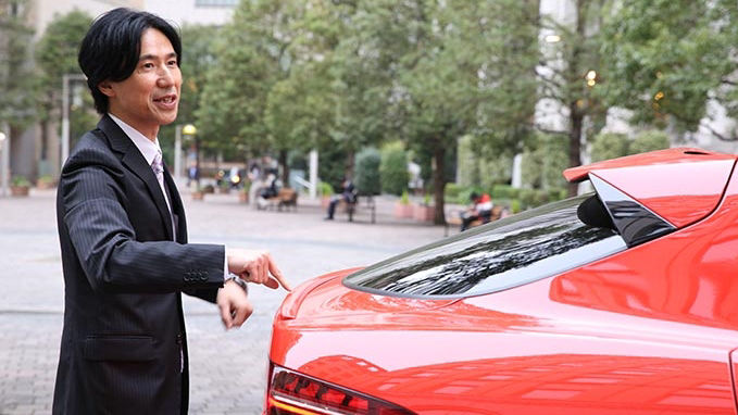 Tatsuya Shiozaki in front of a Jaguar I-Pace