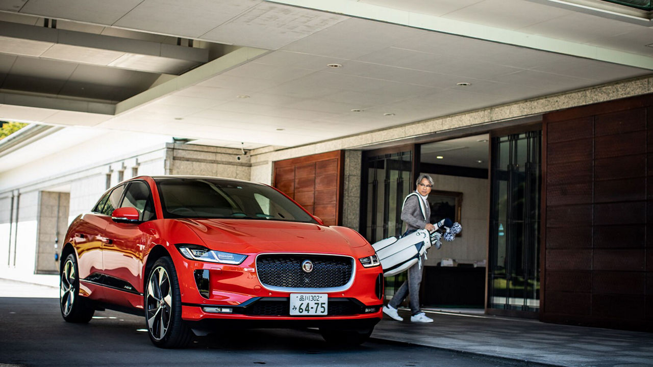 Tatsuya Kushima next to a Jaguar I-Pace