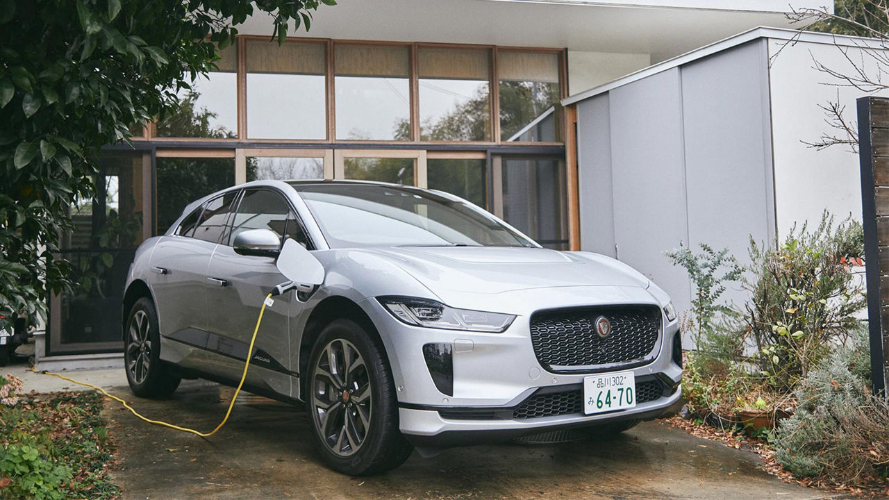 Toshinori Banba is charging a Jaguar I-Pace vehicle