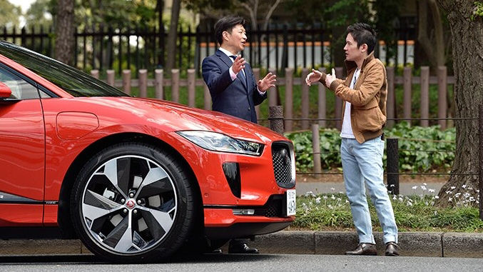 Two man having words in-front of JAGUAR