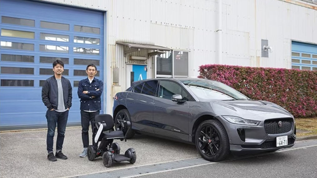 Two people standing in-front JAGUAR