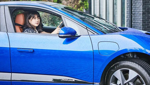 woman driving Blue JAGUAR