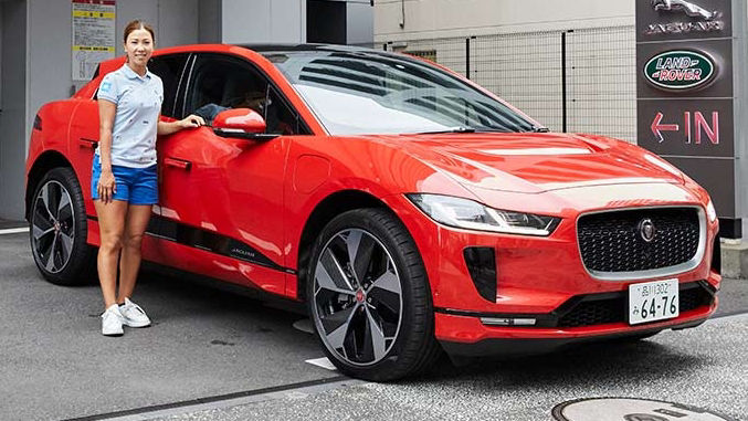 woman posing in-front of Orange JAGUAR