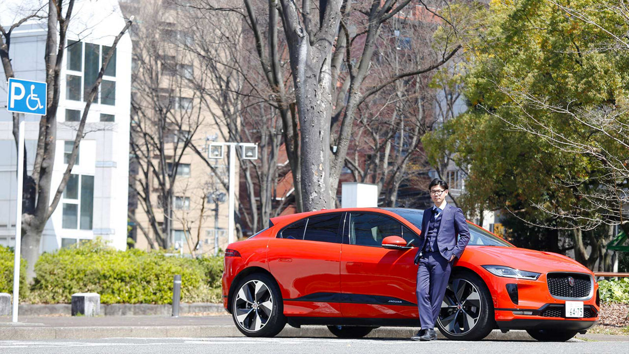 Yukitaka Yoshikawa in front of a Jaguar I-Pace