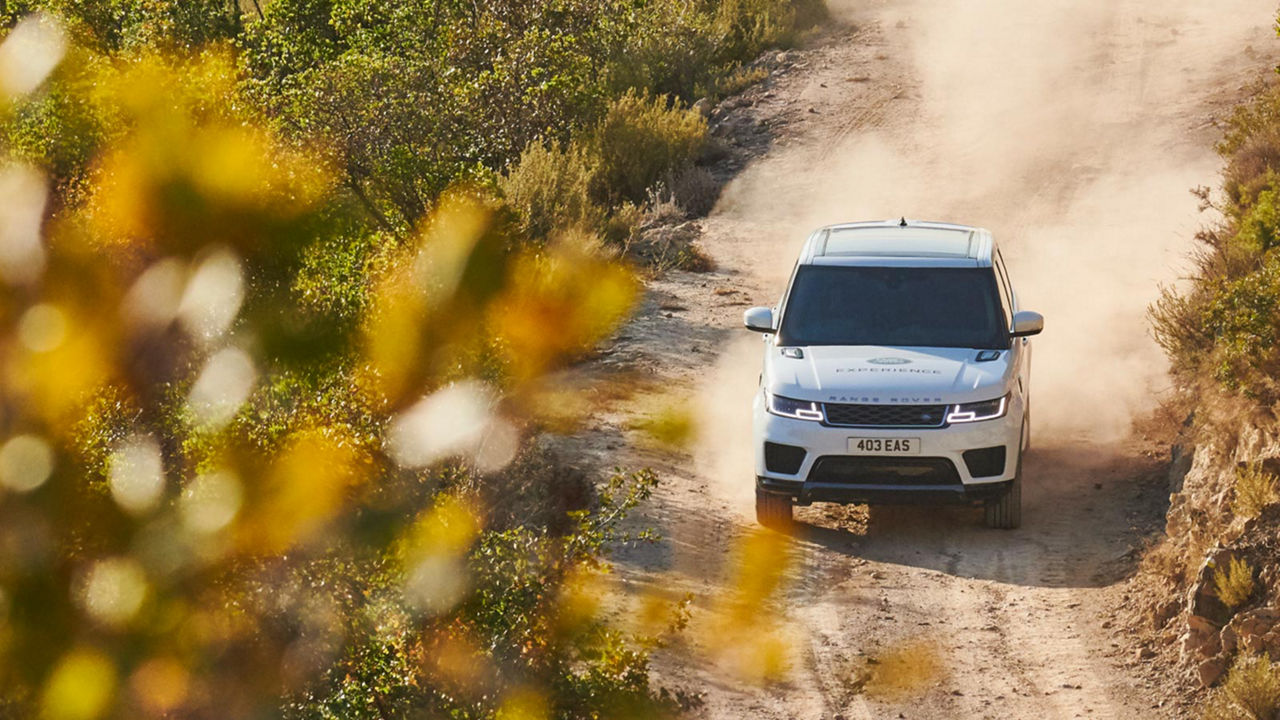 Range Rover driving in sand road