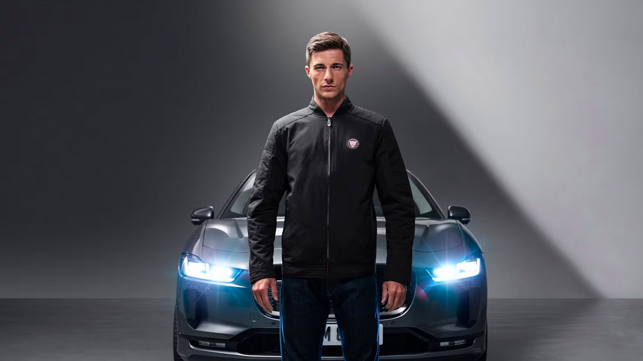 Male model in front of car wearing driver jacket