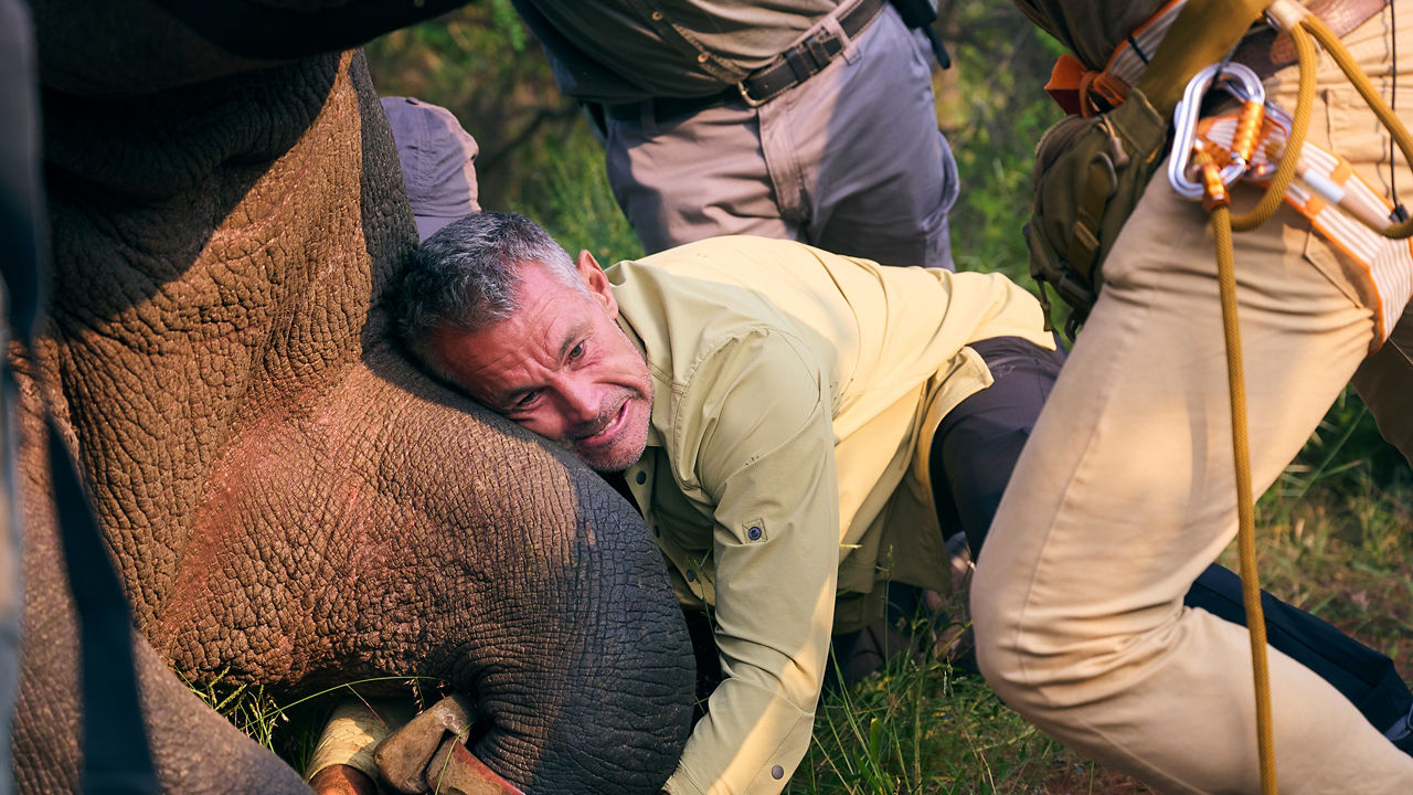 Man holding rhino leg 