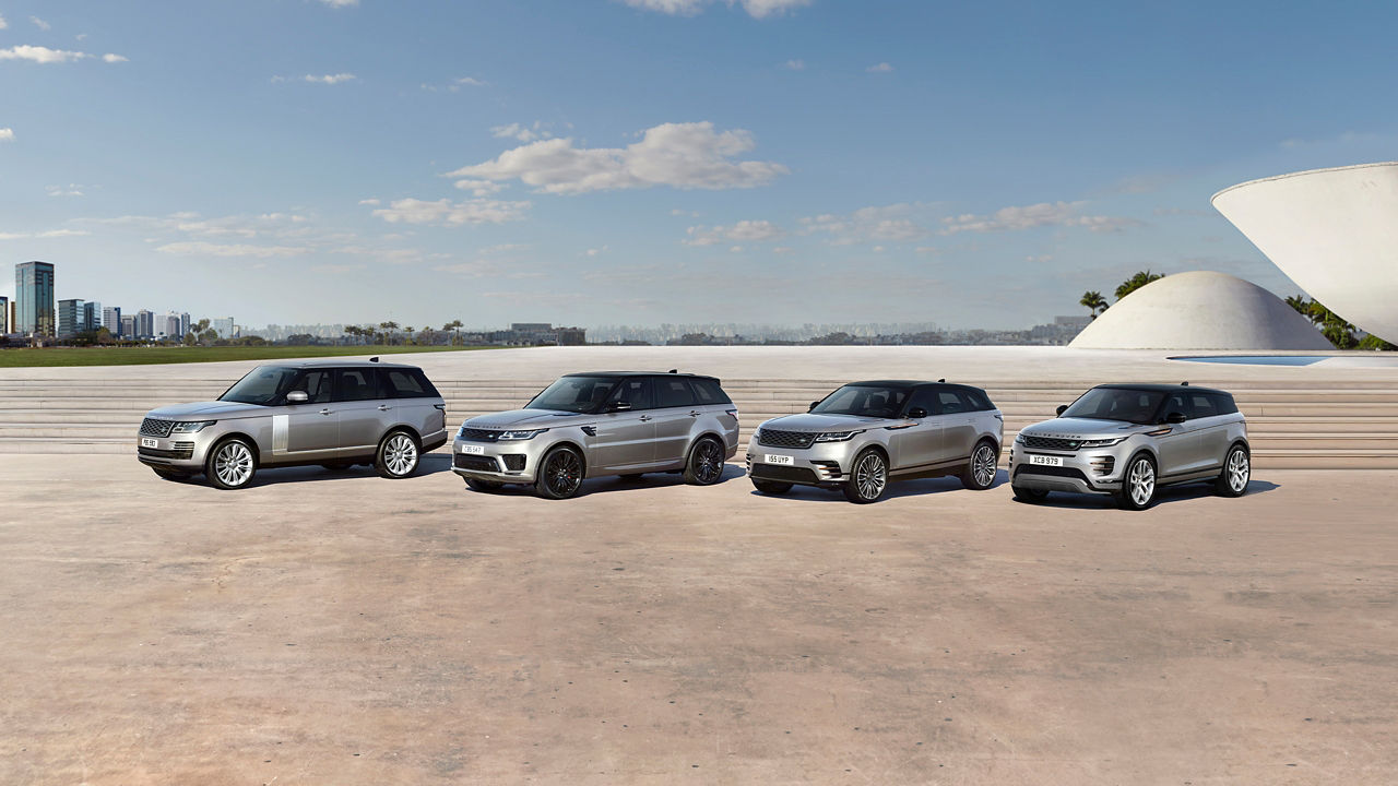 4 different silver Land Rover vehicles lined up next to each other 