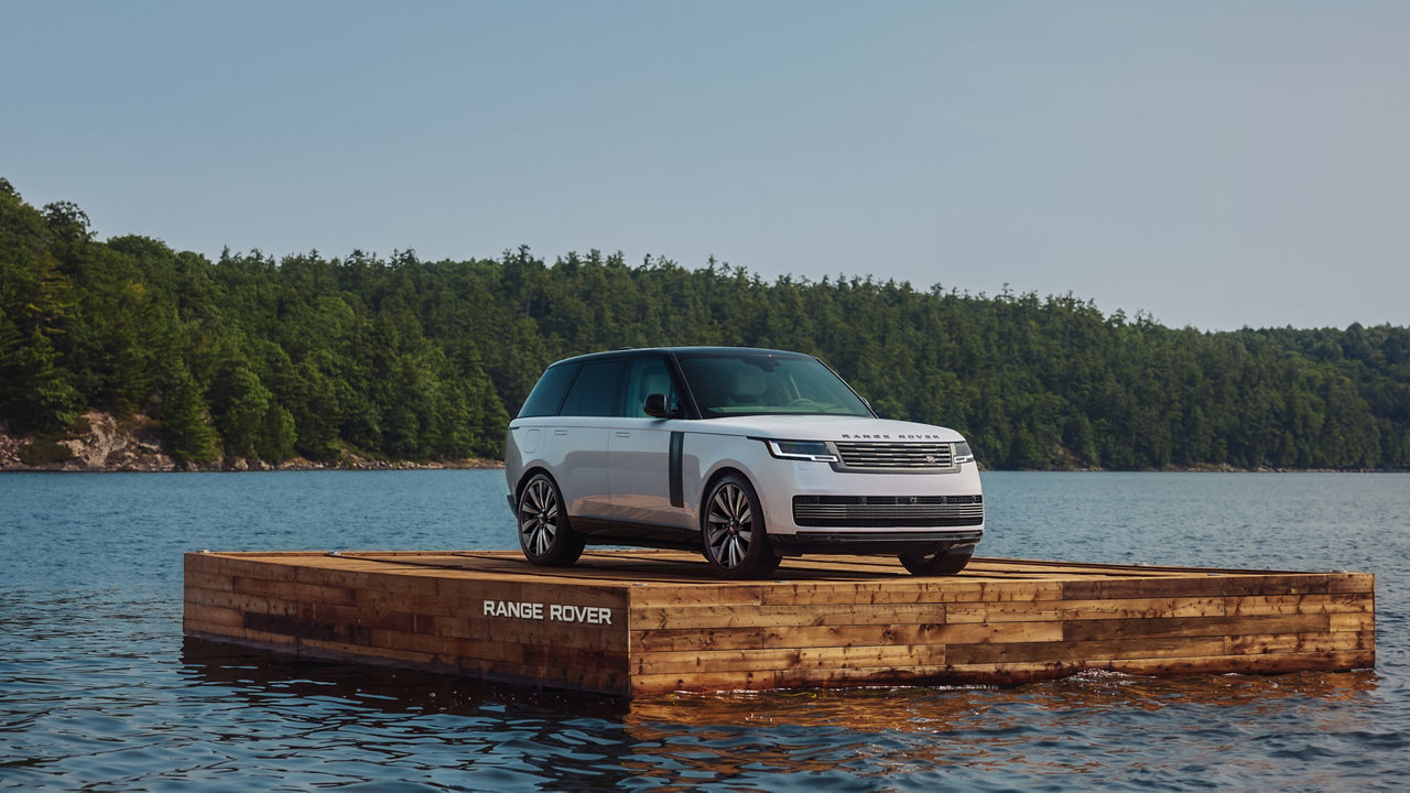 White Range Rover on a wooden platform